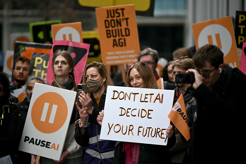 Crowd of AI protesters holding signs including Don't let AI decide your future